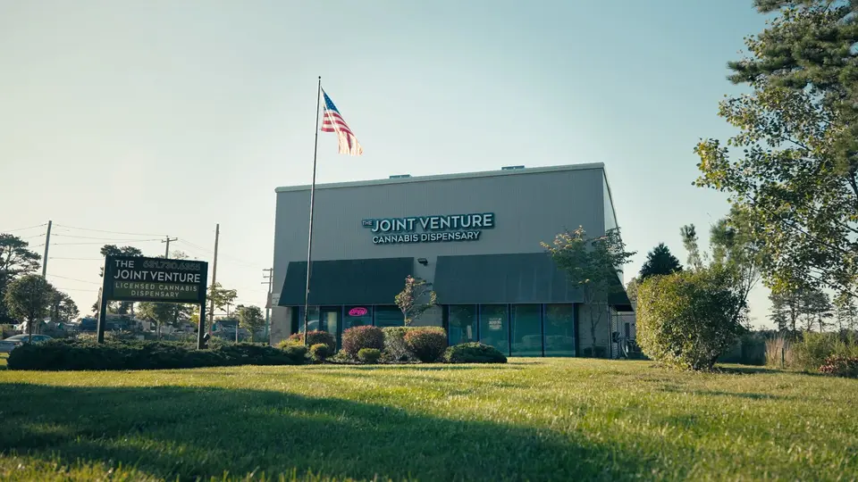 The Joint Venture on Munsell Road in Medford: the building, its roadside sign and the flag out front.